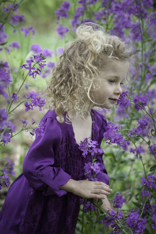 little girl in field of purple flowers