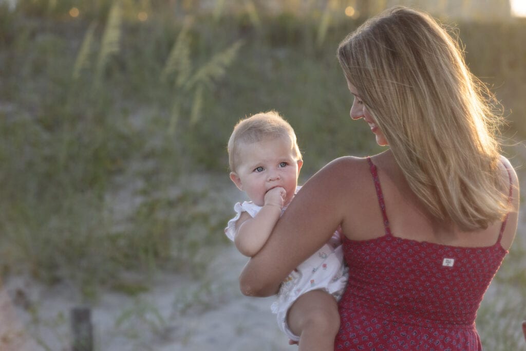 mom and babe on beach at sunset