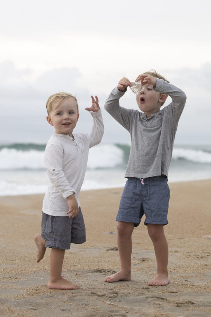 Boys playing with jelly fish on beach Duck NC