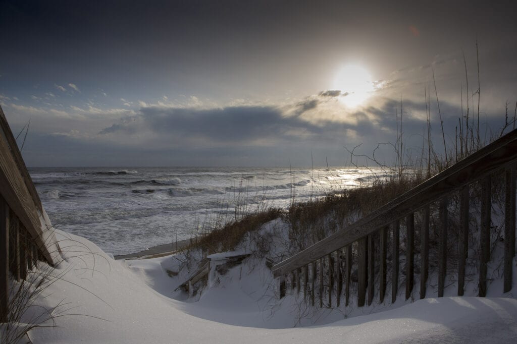 Snowy covered beach with sunrise Duck,NC