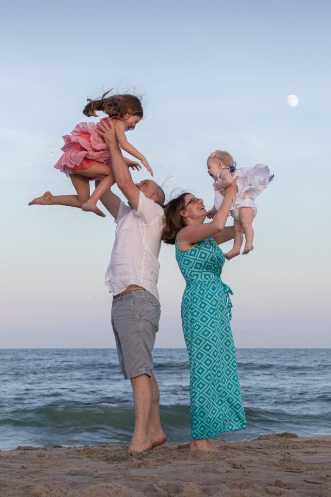 Family on the beach with moon over ocean  Corolla NC