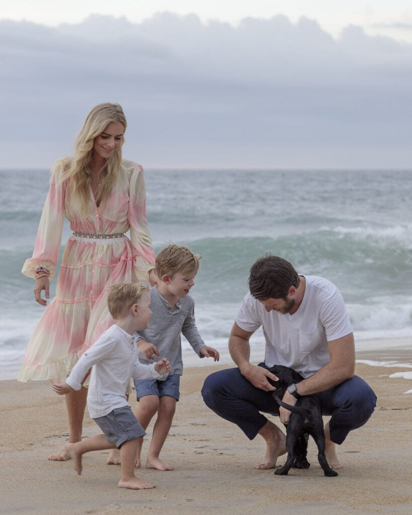 Family on beach with puppy