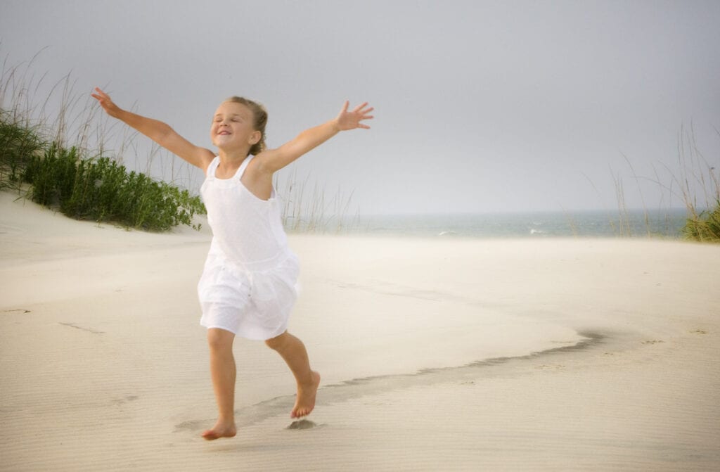 Girl running on beach with love in her expression