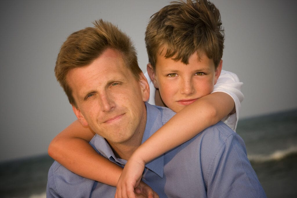 Dad and son enjoying dusk on beaching the Outer Banks