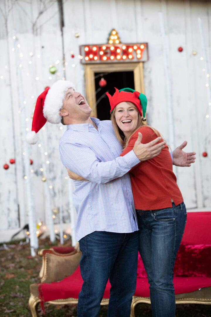 Older couple enjoying the spirit of Christmas by a festive old barn in Loudoun County