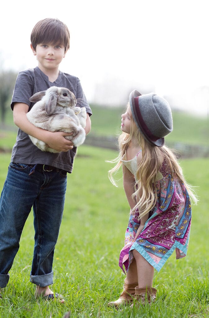 Boy and girl on the farm with animals