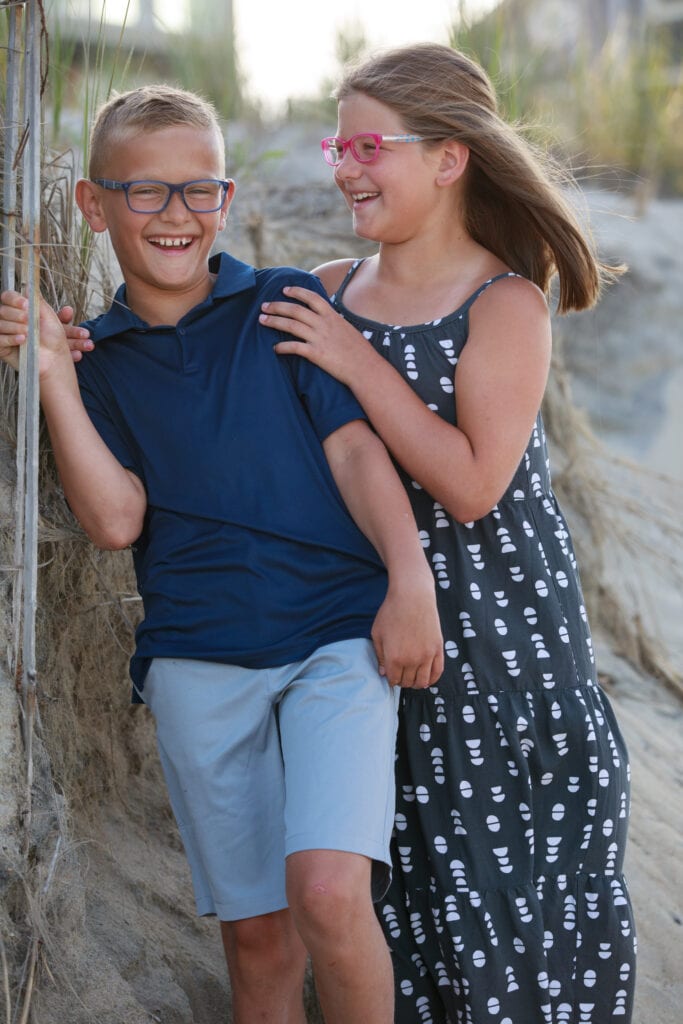 Brother and sister laughing on beach , Duck, NC