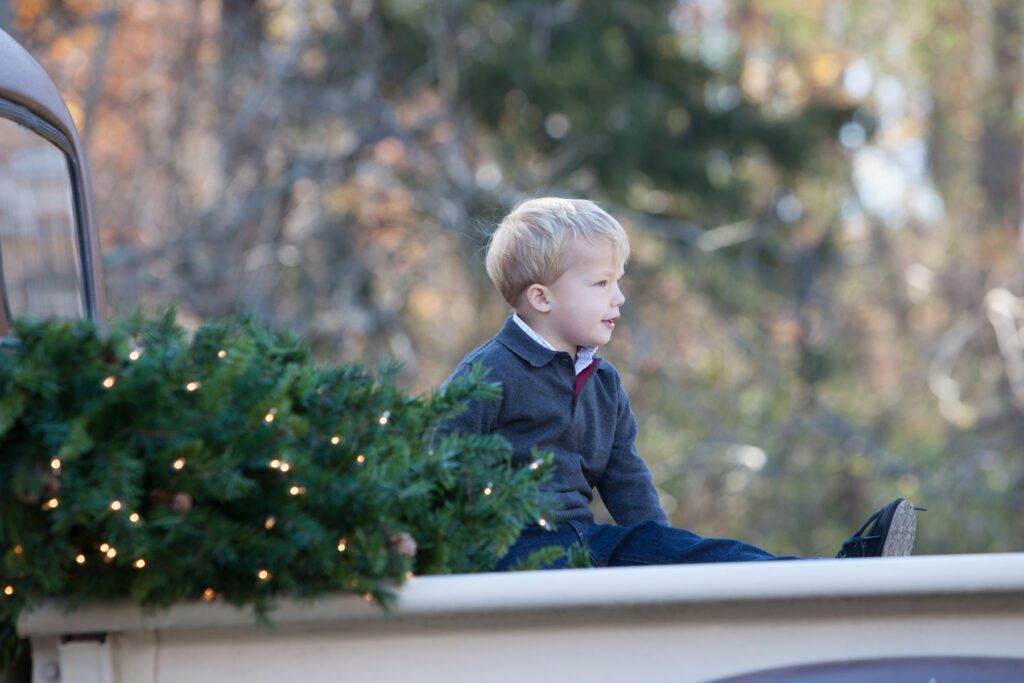 Little boy on vintage truck with Christmas tree Loudoun County