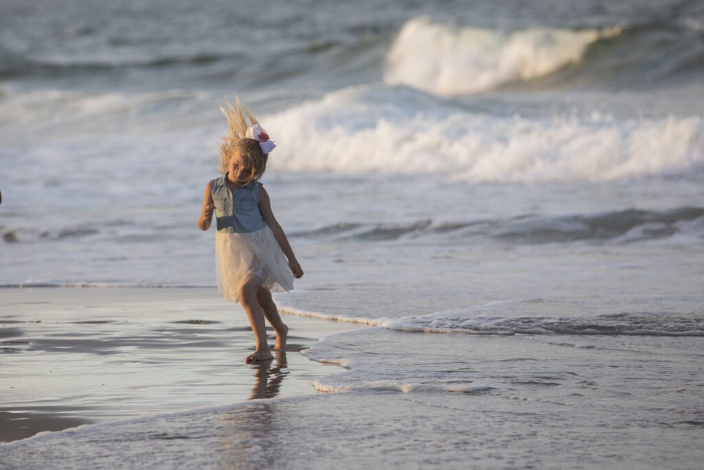 Little girl dancing on the beach Duck research pier