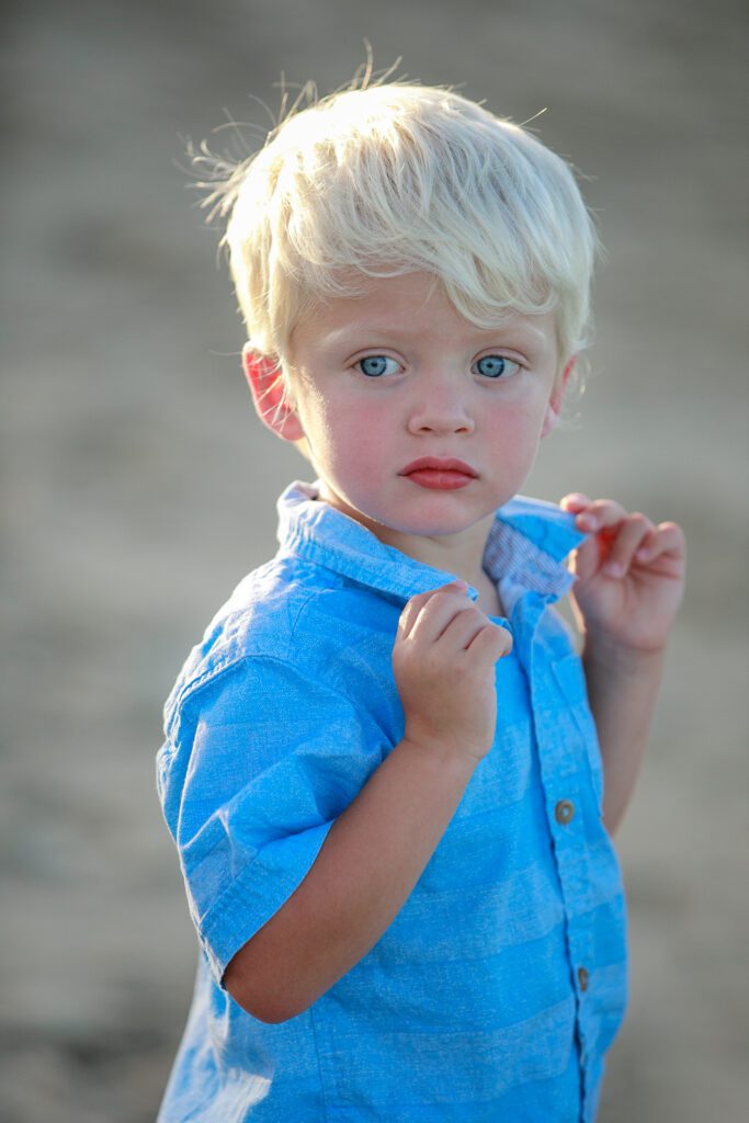 beautiful blue eyed baby boy on the beach