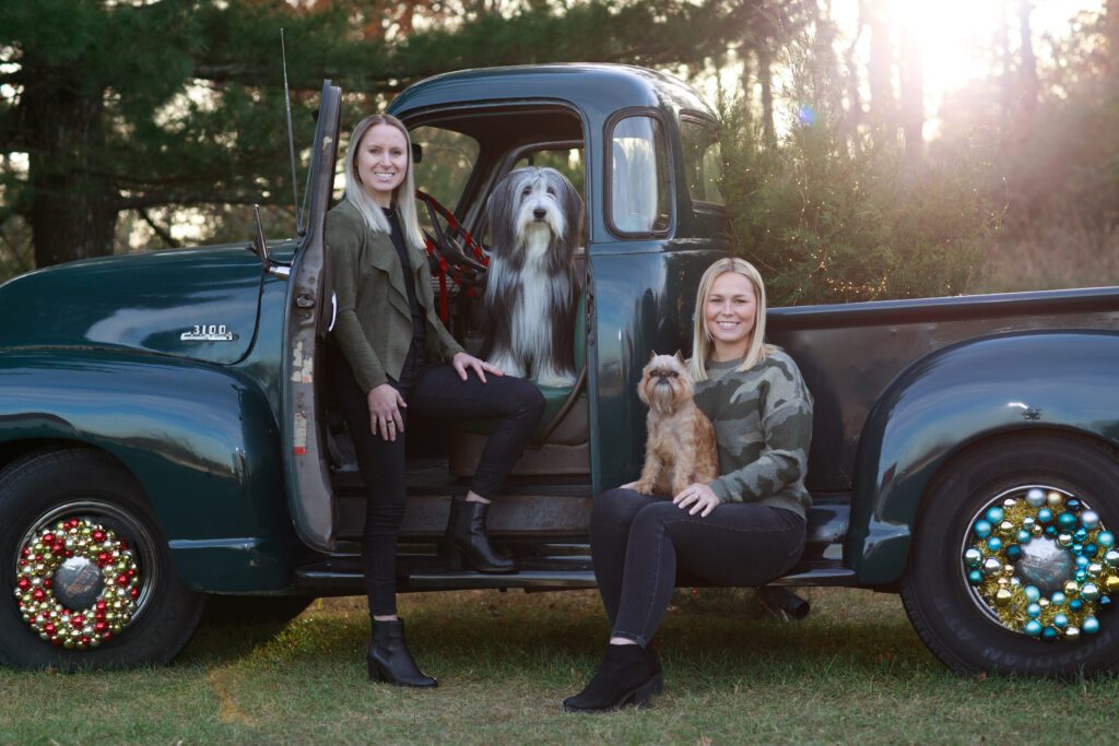 Sisters on old truck with dogs in Leesburg Virginia