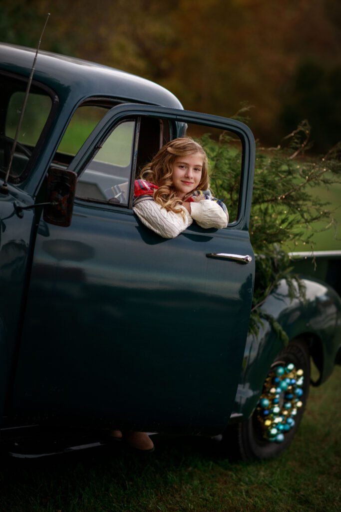 Girl in old truck for holidays
