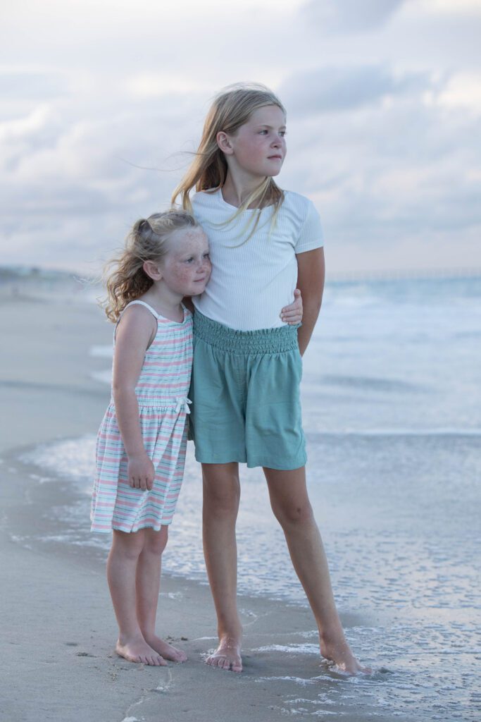 A quiet moment between two sisters on the beach in Duck, NC