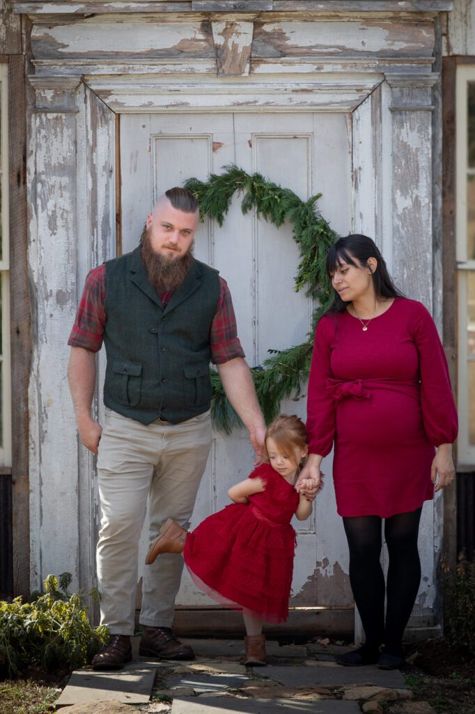 Mom and Dad with small child and cild on the way in a holiday set Loudoun County Virginia