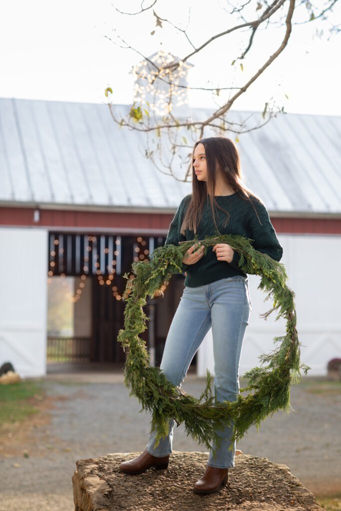 Girl with large wreath in a Christmas country setting