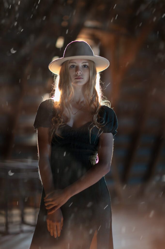 Girl with large hat in old barn, with magic dust