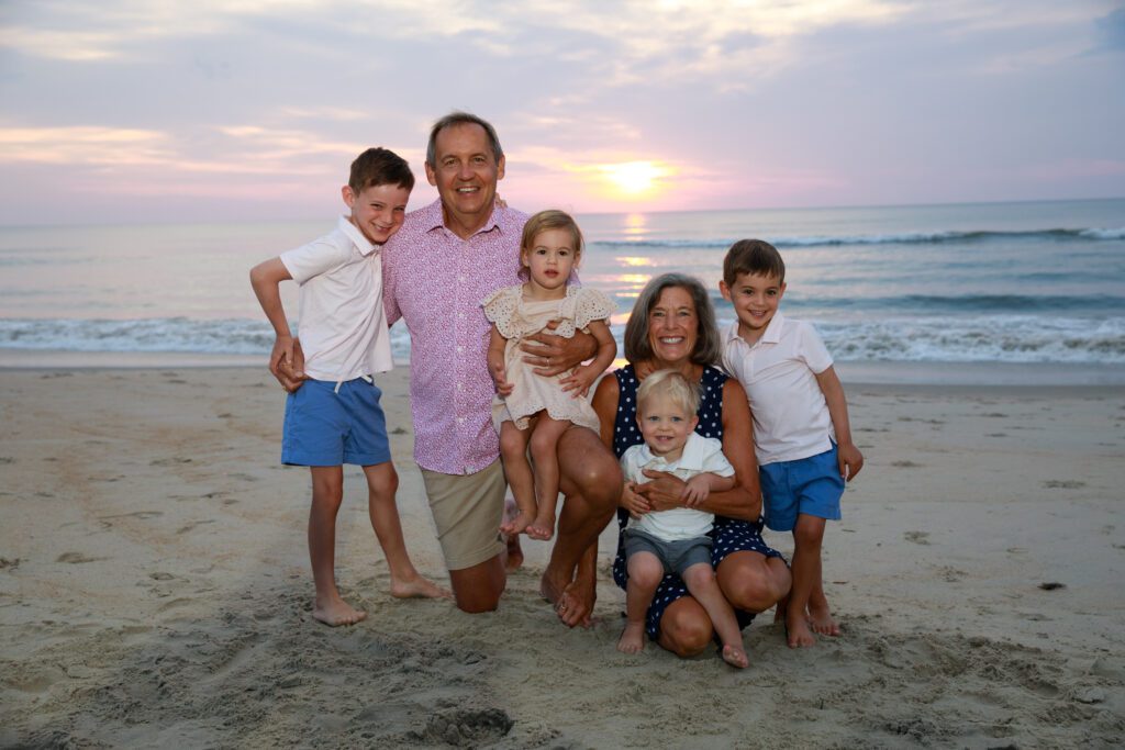 Grandparents with grandchildren at sunrise on the beach in Duck NC