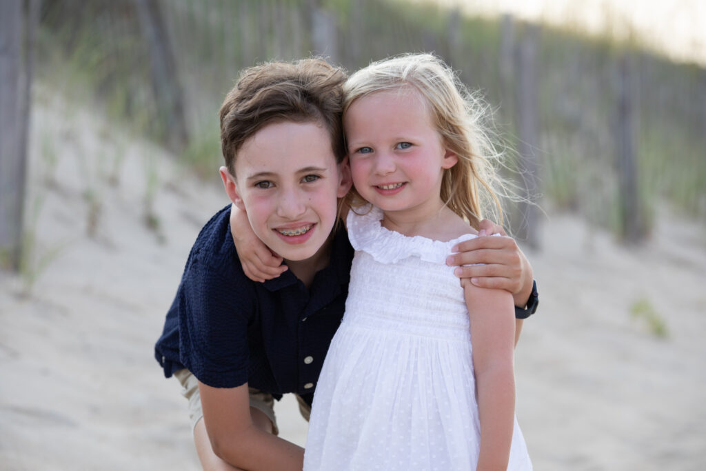 brother and sister by the sand dune in Duck NC