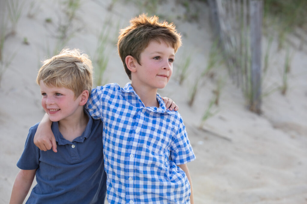 brothers enjoying the golden hour on the beach in duck nc