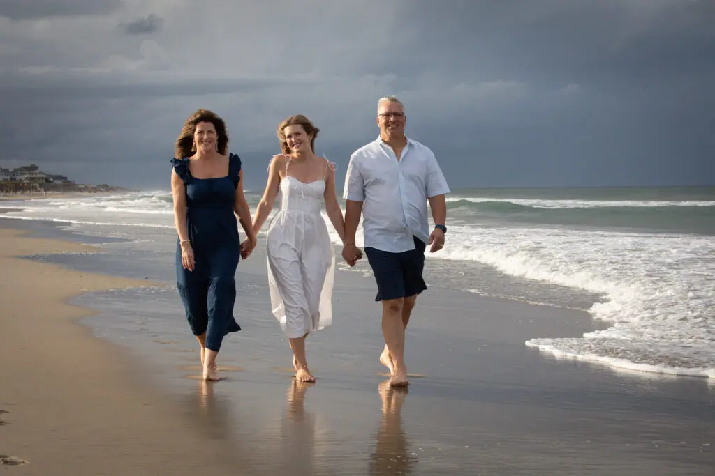 Mom and Dad on the beach with a brilliant storm brewing in the background.