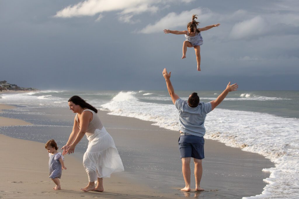 Family on the beach in beautiful storm light in Corolla, NC