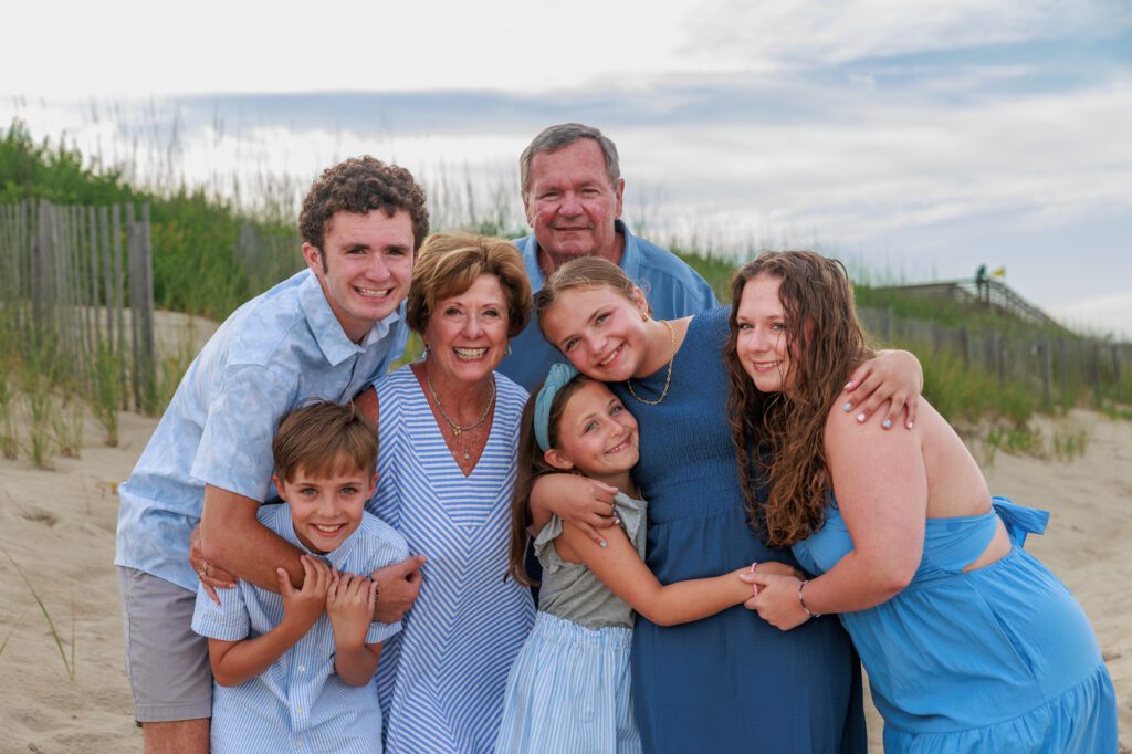grandparents on the beach with grandkids