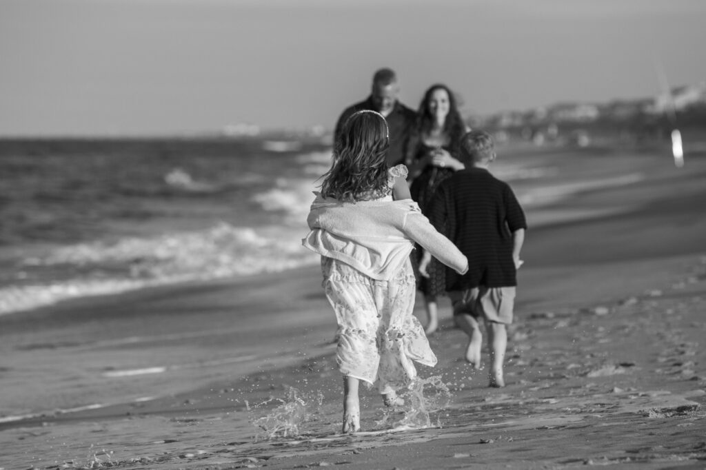 family running along the beach in Duck, NC