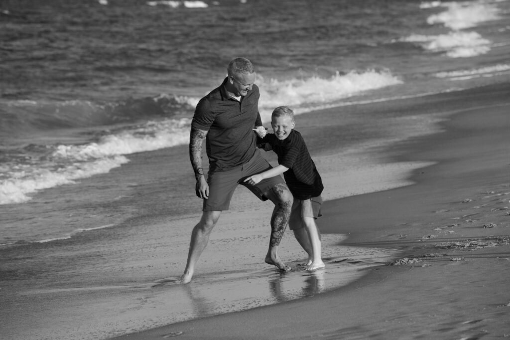 father and son playing along the beach in Duck, NC