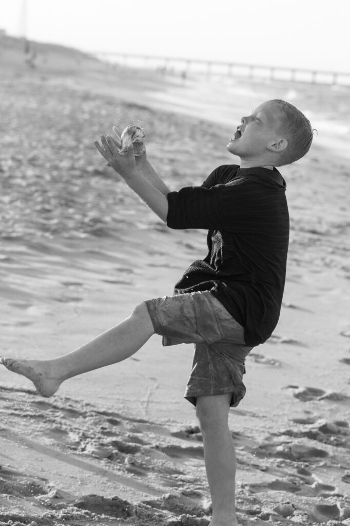 Boy catching a shell in Duck, NC