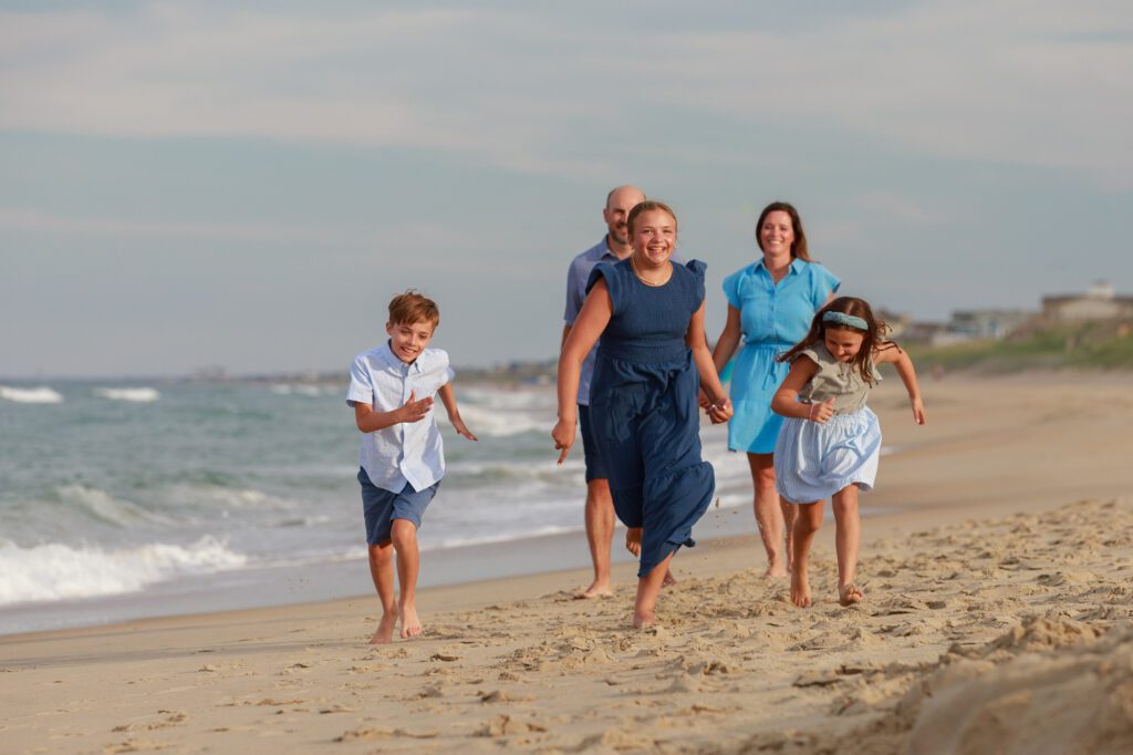 family running along the beach in Duck, NC