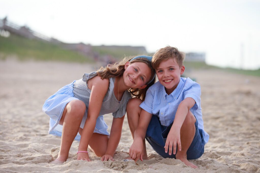 Brother and sister hanging out on the beach in Duck, NC