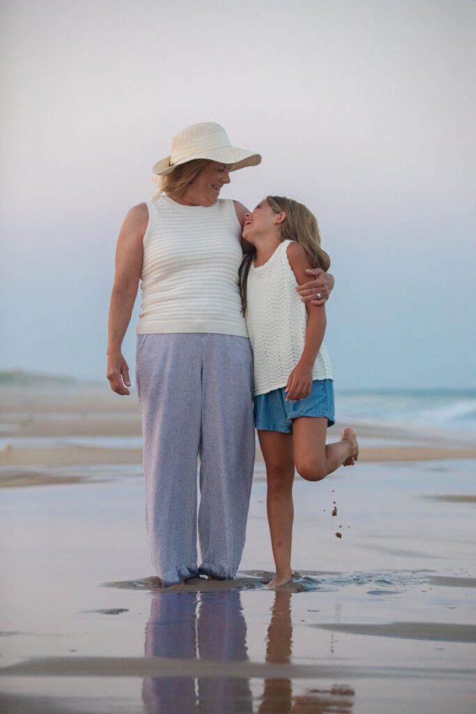 Granddaughter and Grandmothering enjoying sunset on the beaches of the Outer Banks
