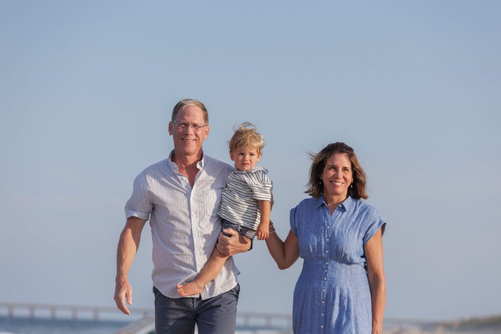 Grandparents with grandson on the beach in Duck, NC